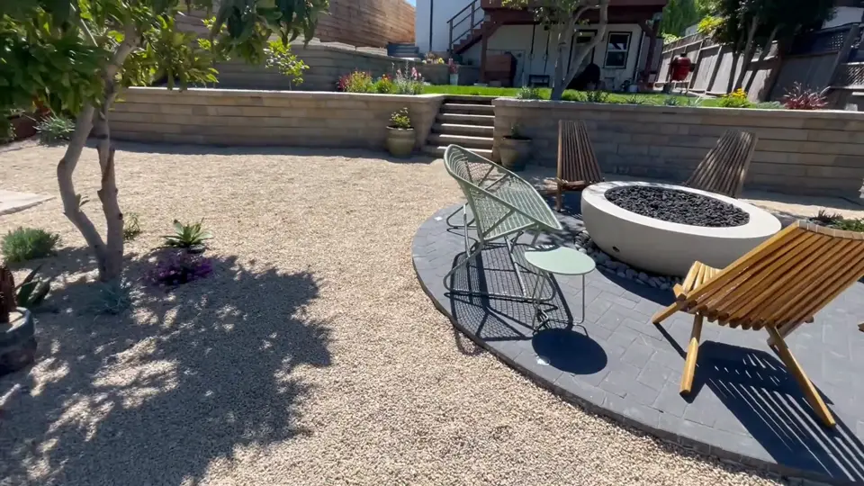 Block steps built into a retaining wall leading up to a lawn