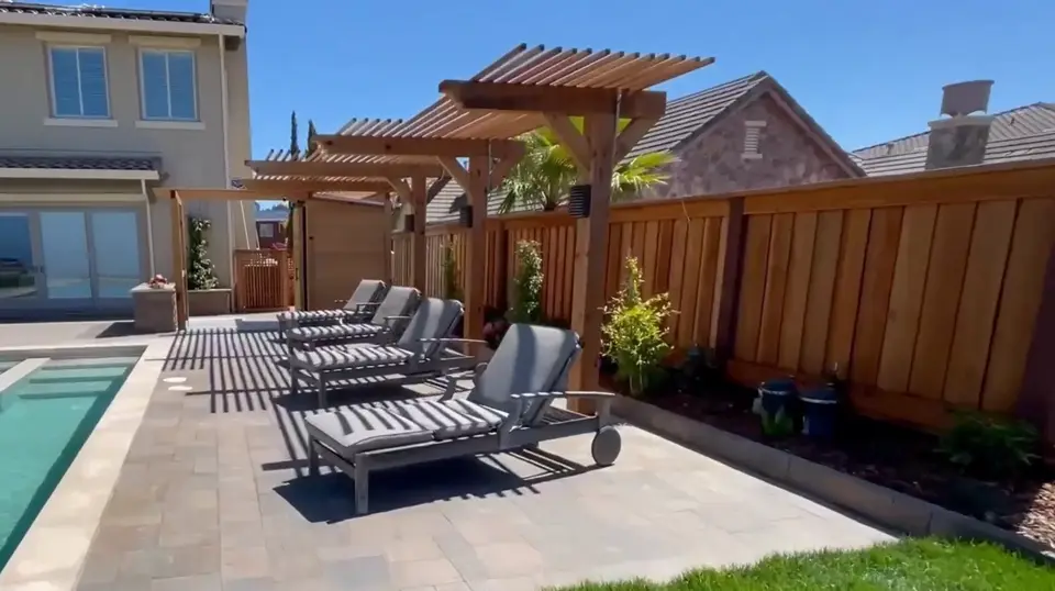 Renovated pool deck with new hardscape surface and lounge chairs