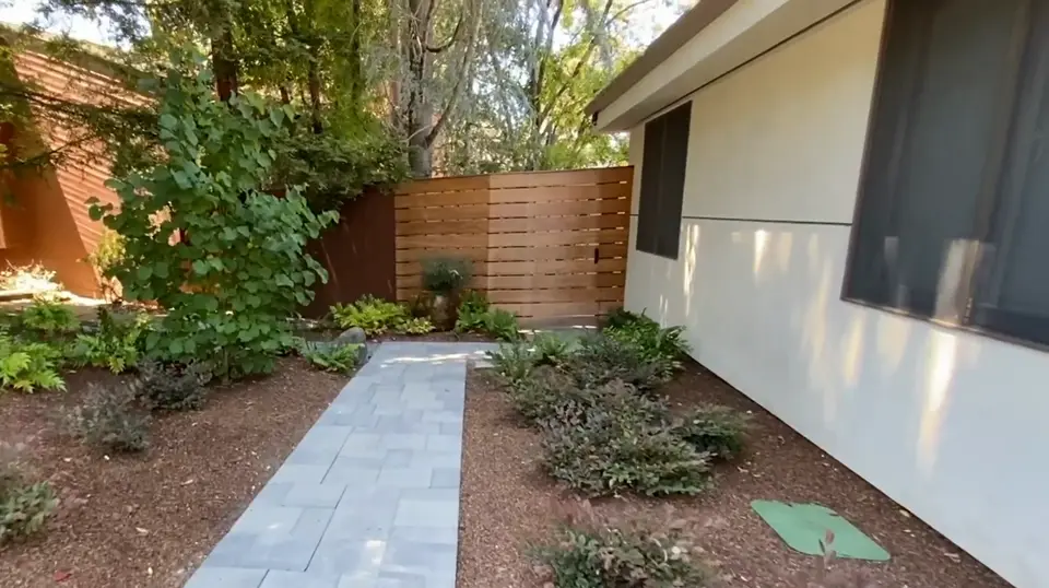 Paver side walkway lined with fresh drought-tolerant planting